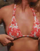 Close-up woman wearing a reversible floral knoted bikini top